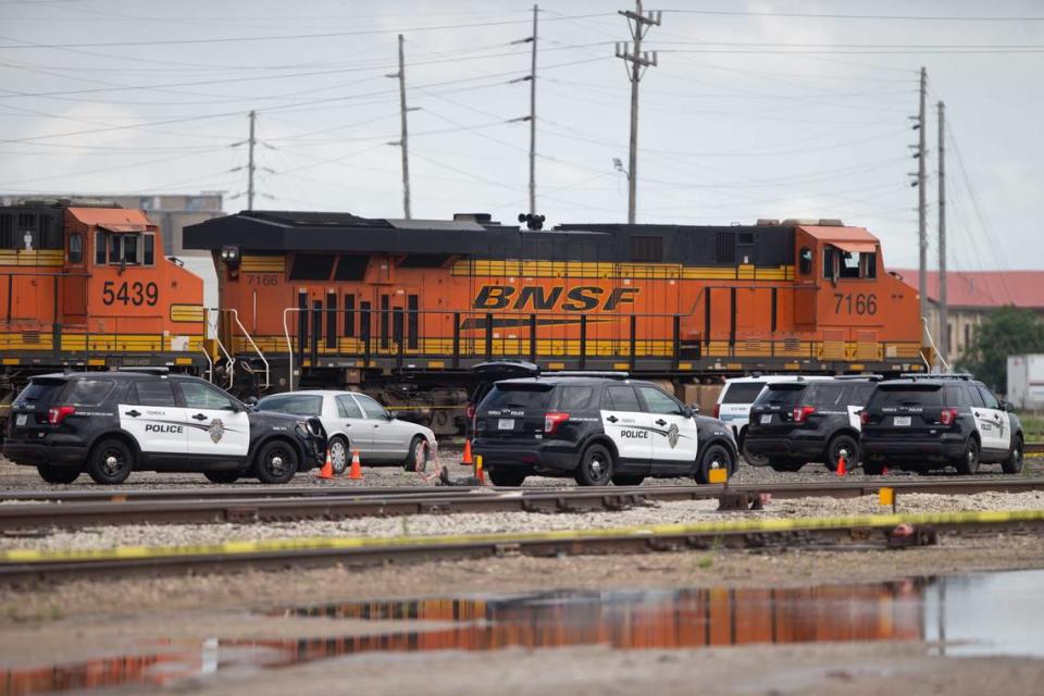 Patrol vehicles for the Topeka Police Department and the Shawnee County Sheriff’s Office are seen parked within a taped off portion of railroad tracks just north of the Amtrak Station after officers shot and killed Christopher Kelley in June 2022.