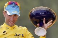 Race winner Vincenzo Nibali of Italy, wearing the overall leader's yellow jersey, gestures as he celebrates on the podium of the Tour de France in Paris, France, Sunday, July 27, 2014. (AP Photo/Christophe Ena)