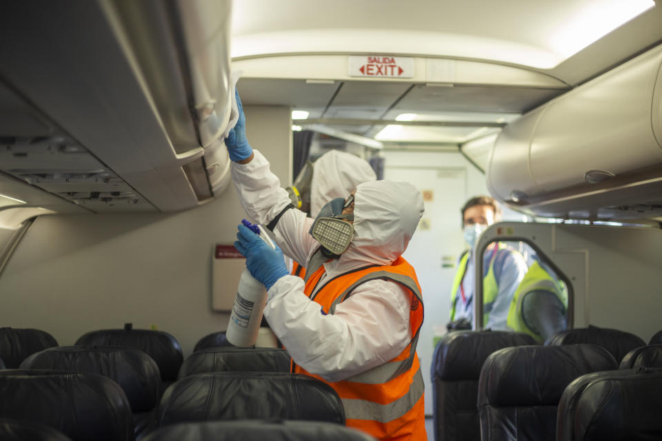 Person disinfects a commercial airplane of the Latam company on September 9, 2020 in Bogota Airport, Colombia. (Photo by Daniel Garzon Herazo/NurPhoto via Getty Images)