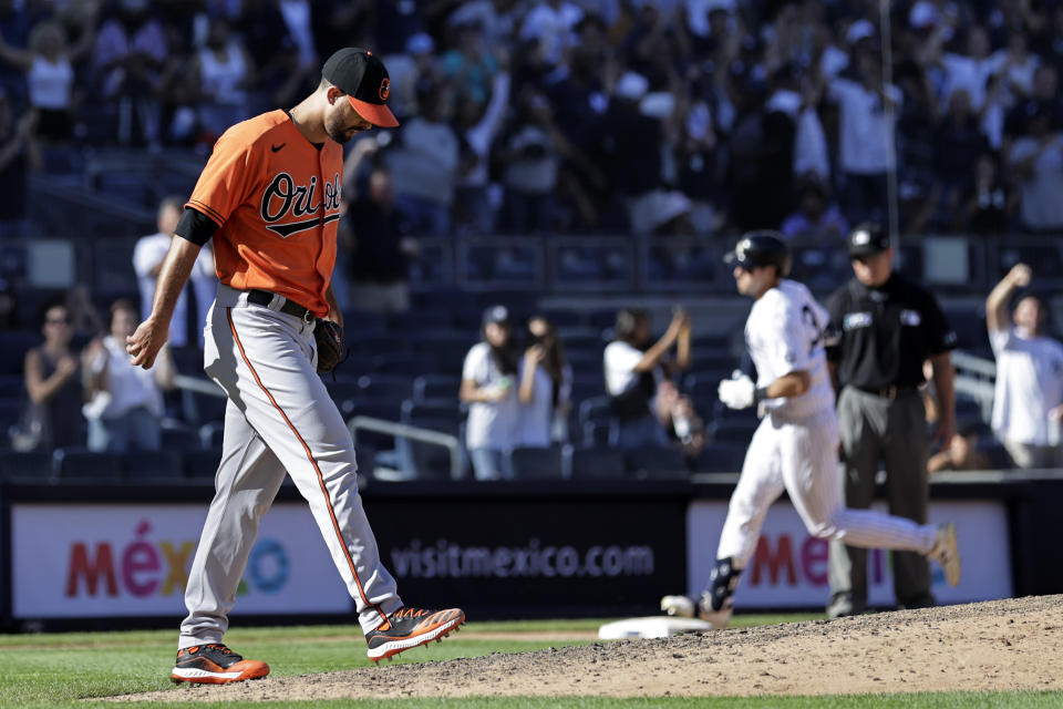 Baltimore Orioles pitcher Jorge Lopez, left, reacts after giving up a two-run home run to New York Yankees' Joey Gallo during the eighth inning of a baseball game on Saturday, Sept. 4, 2021, in New York. (AP Photo/Adam Hunger)