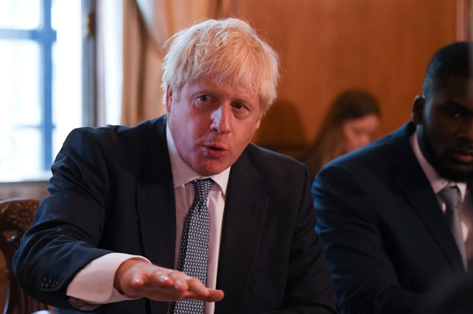 Britain's Prime Minister Boris Johnson (L) speaks flanked by Youth Justice Board Adviser Roy Sefa-Attakora (R) during a roundtable on the criminal justice system at 10 Downing Street in London on August 12, 2019. (Photo by Daniel LEAL-OLIVAS / POOL / AFP)        (Photo credit should read DANIEL LEAL-OLIVAS/AFP/Getty Images)