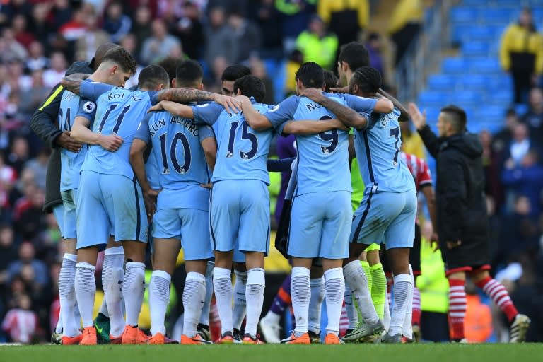 Manchester City players form a group huddle on the pitch on October 23, 2016