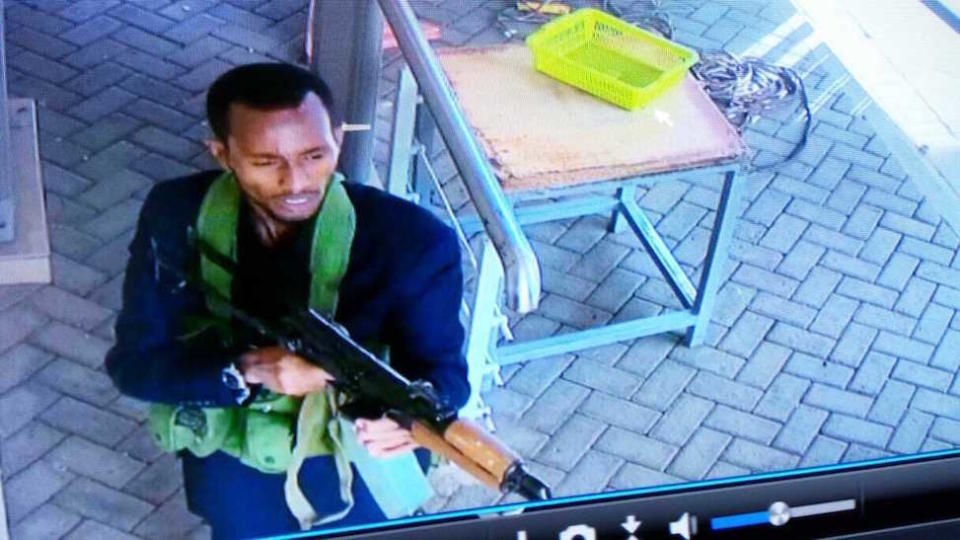 In this grab taken from security camera footage, an armed attacker walks in the compound of the hotel in Nairobi (Picture: AP)