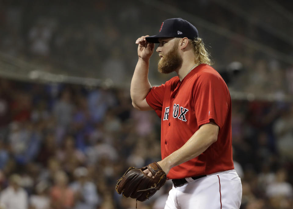 Boston Red Sox starting pitcher Andrew Cashner tips his cap to cheering fans as he comes out of the baseball game in the seventh inning against the New York Yankees at Fenway Park, Friday, July 26, 2019, in Boston. (AP Photo/Elise Amendola)