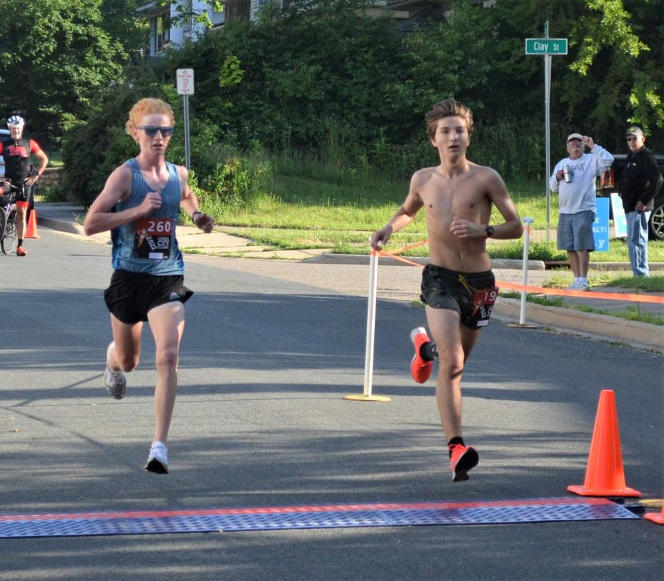 Due to a staggered start, the 5k and the 10k winners for the Cereal City Classic finished at the same time with Battle Creek's Aiden Moore, left, winning the 5k and Ethan Saylor of Dowagiac winning the 10k.