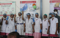 Health workers celebrate India administering 1 billion doses of COVID-19 vaccine, at Rajawadi hospital in Mumbai, India, Thursday, Oct. 21, 2021. India has administered 1 billion doses of COVID-19 vaccine, passing a milestone for the South Asian country where the delta variant fueled its first crushing surge this year. (AP Photo/Rajanish Kakade)