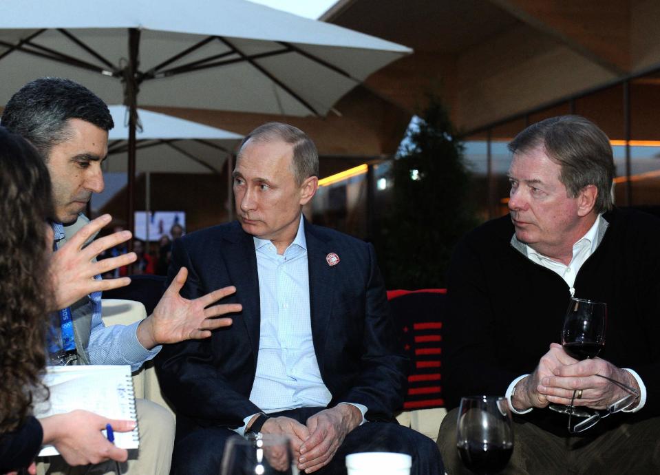 Russian President Vladimir Putin, center, speaks with Head of the NBC Olympic Department Gary Zenkel, left, and member of the International Olympic Committee Larry Probst, right, while visiting USA House during the 2014 Winter Olympics, Friday, Feb. 14, 2014 in Sochi, Russia. (AP Photo/RIA-Novosti, Mikhail Klimentyev, Presidential Press Service)