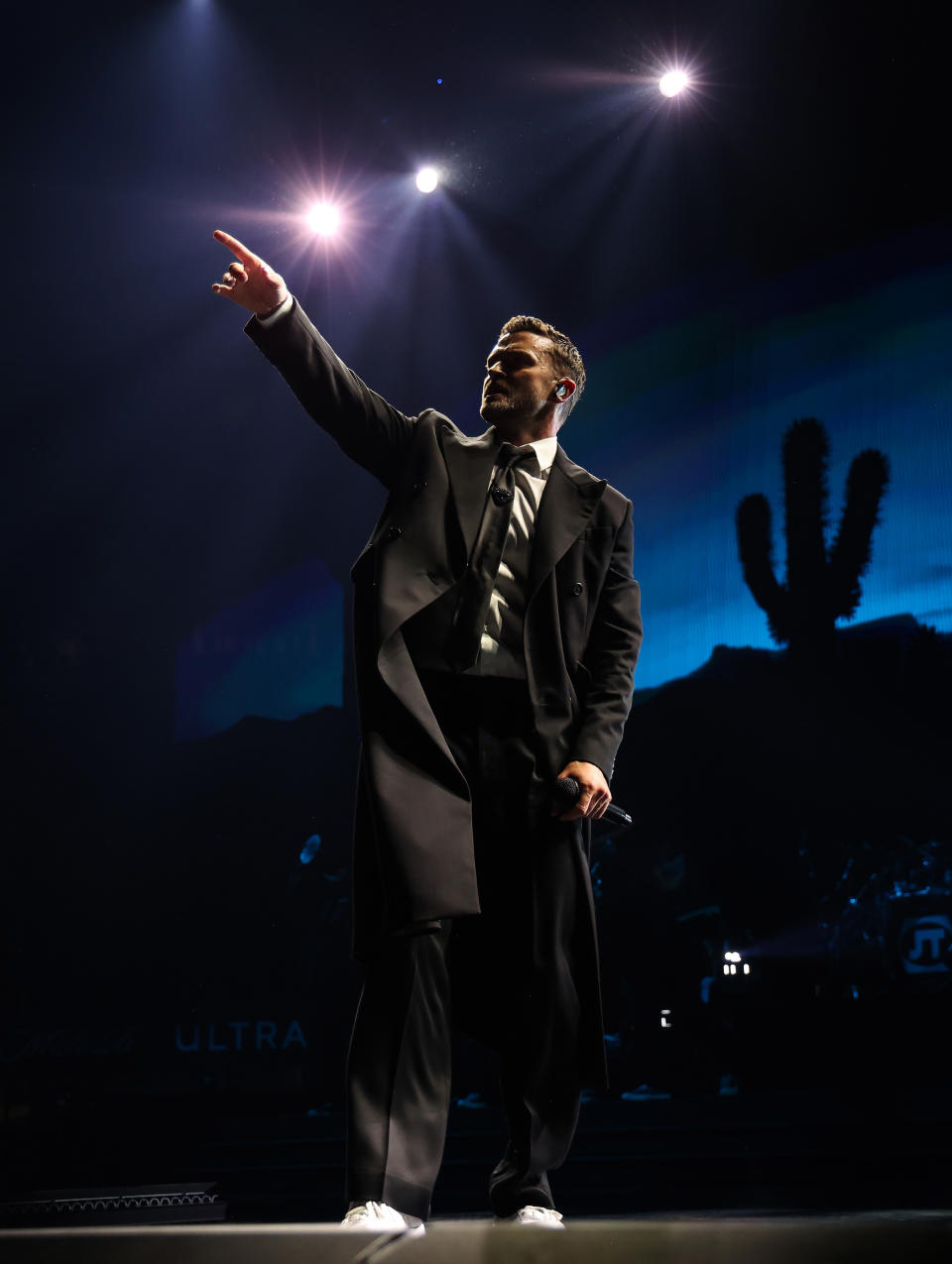 Justin Timberlake points with his left hand while holding a microphone in his right hand, on stage at Madison Square Garden in New York. 