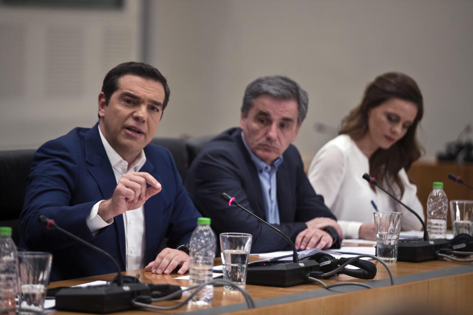 Greek Prime Minister Alexis Tsipras, left, announces bailout relief measures next to Greek Financial Minister Euklid Tsakalotos center, and Greek Labour Minister Effie Achtsioglou, right, during a press conference, in Athens, on Tuesday, May 7, 2019. Greece's left-wing prime minister has promised crisis-weary voters a series of tax-relief measures ahead of elections, after outperforming budget targets set by bailout creditors. (AP Photo/Petros Giannakouris)