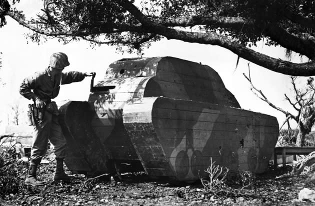 A U.S. marine rips a board from a Japanese decoy tank, used to attract enemy fire away from the real ones, between April and July 1945. More <a href="http://www.theatlantic.com/photo/2016/04/bamboo-bombers-and-stone-tanksjapanese-decoys-used-in-world-war-ii/480186/?utm_source=yahoo" rel="nofollow noopener" target="_blank" data-ylk="slk:here;elm:context_link;itc:0;sec:content-canvas" class="link ">here</a>. (Corbis)