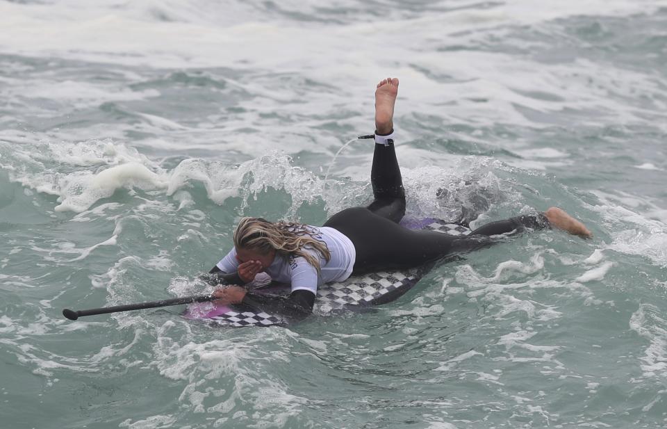 Isabella Gomez of Colombia celebrates wining the gold for paddle during women's SUP surfing events at the Pan American Games on Punta Rocas beach in Lima, Peru, Sunday, Aug. 4, 2019. (AP Photo/Martin Mejia)