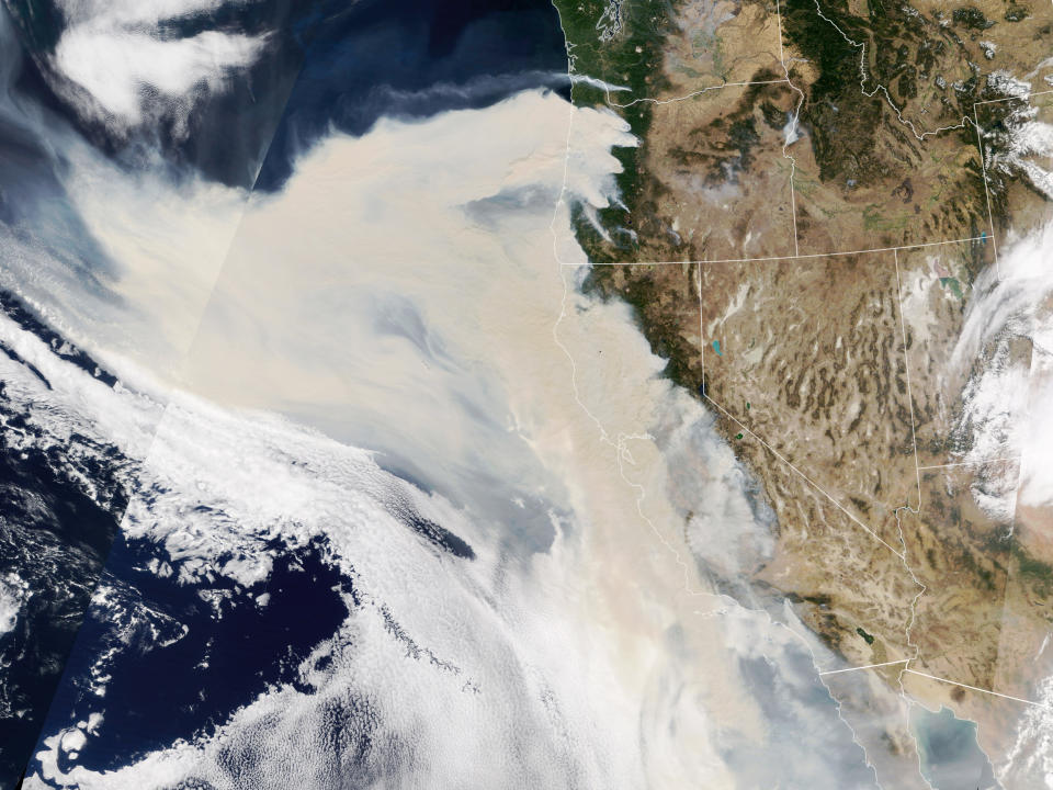 Thick smoke streams from intense fires in Oregon and California on Sept. 9. The smoke was so thick and widespread that it was easily visible 1 million miles away from Earth. (NASA Earth Observatory)