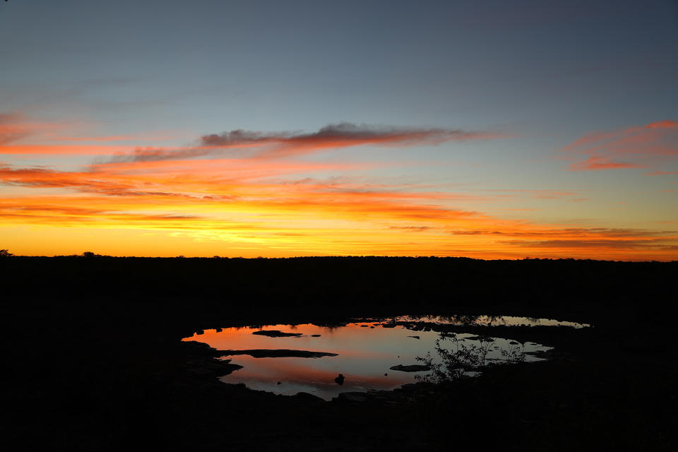 Another dramatic sunset at the Moringa waterhole, always worth the price of admission. Sunsets are quiet, with only the sounds of wildlife and cameras clicking. (Photo: Gordon Donovan/Yahoo News)