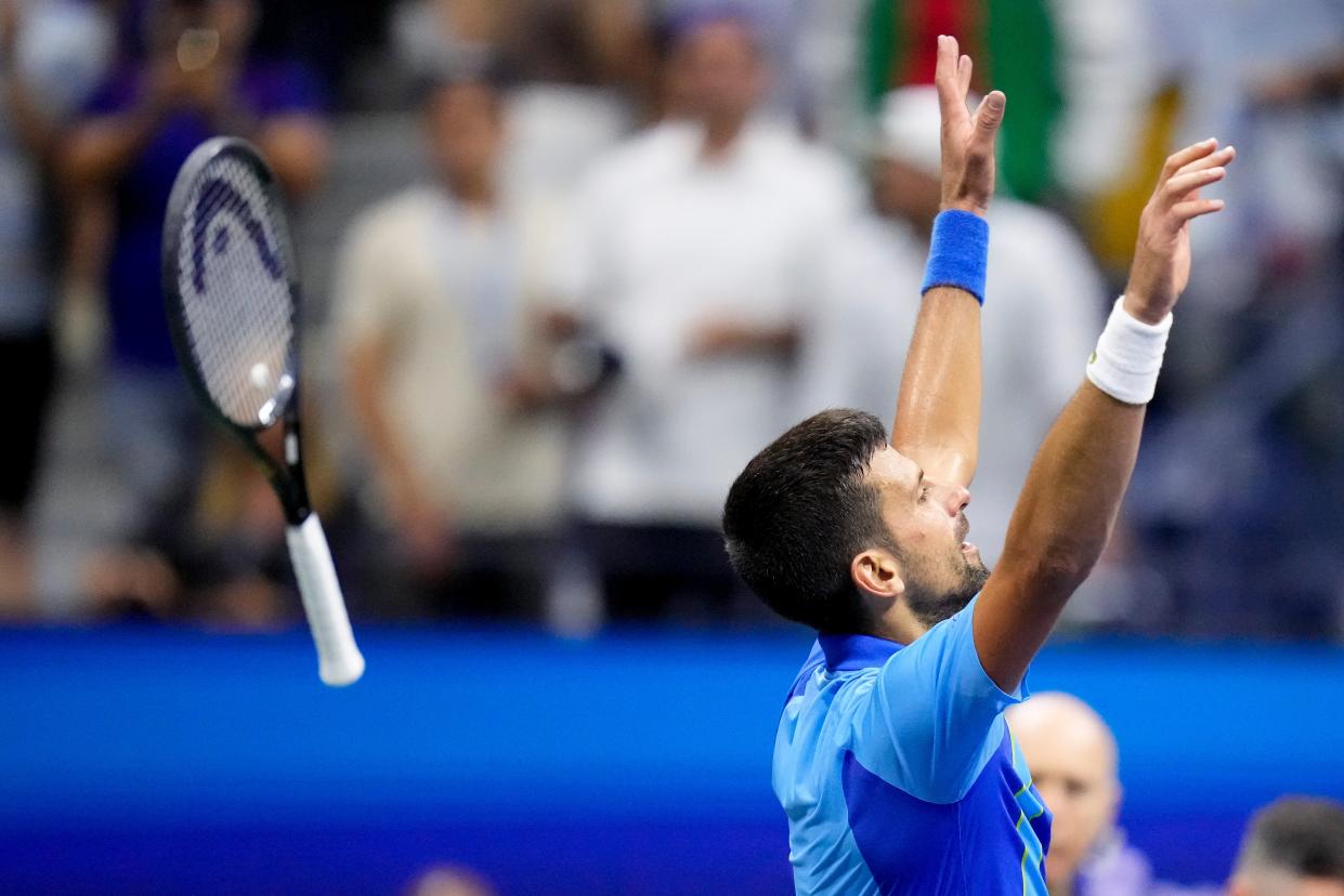 Novak Djokovic, of Serbia, tosses his racket after defeating Daniil Medvedev (AP)