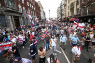 <p>Free Tommy Robinson supporters and pro-Trump supporters come together on Whitehall, London, for a joint rally in support of the visit of the U.S. president to the U.K. and calling for the release of jailed right-wing activist Tommy Robinson. (Photo: Yui Mok/PA Images via Getty Images) </p>