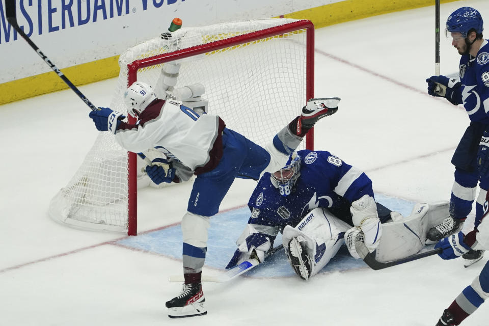 Colorado Avalanche center Nazem Kadri shoots the puck past Tampa Bay Lightning goaltender Andrei Vasilevskiy (88) for a goal during overtime of Game 4 of the NHL hockey Stanley Cup Finals on Wednesday, June 22, 2022, in Tampa, Fla. (AP Photo/John Bazemore)