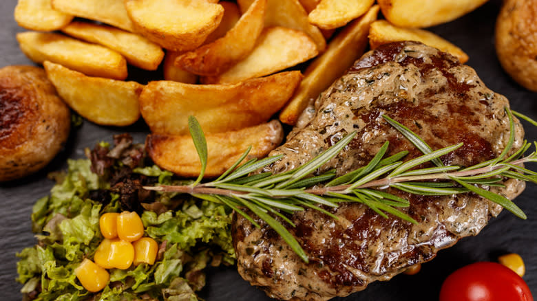 steak with fries and rosemary