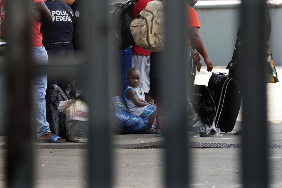 In this May 28, 2019 photo, migrants wait for a turn to register for a chance to start the normalization of their arrival, at a migration center in Tapachula, Chiapas state, Mexico. Washington has demanded Mexico significantly slow a surge of mostly Central Americans fleeing poverty and violence but also Cubans, Haitians and Africans make up the surge. (AP Photo/Marco Ugarte)