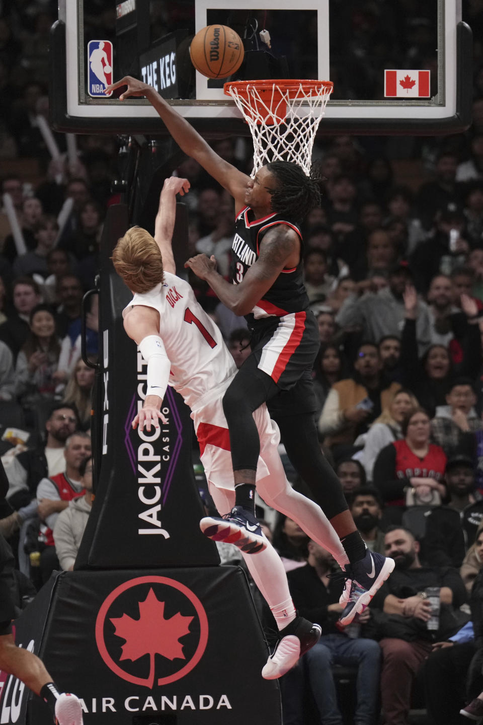 Portland Trail Blazers forward Jabari Walker, right, rejects Toronto Raptors guard Gradey Dick (1) at the basket during second-half NBA basketball game action in Toronto, Monday, Oct. 30, 2023. (Nathan Denette/The Canadian Press via AP)