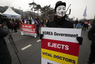 A doctors wearing a mask arrives to attend a rally against the government's medical policy in Seoul, South Korea, Sunday, March 3, 2024. Thousands of senior doctors rallied in Seoul on Sunday to express their support for junior doctors who have been on strike for nearly two weeks over a government plan to sharply increase the number of medical school admissions. (AP Photo/Ahn Young-joon)