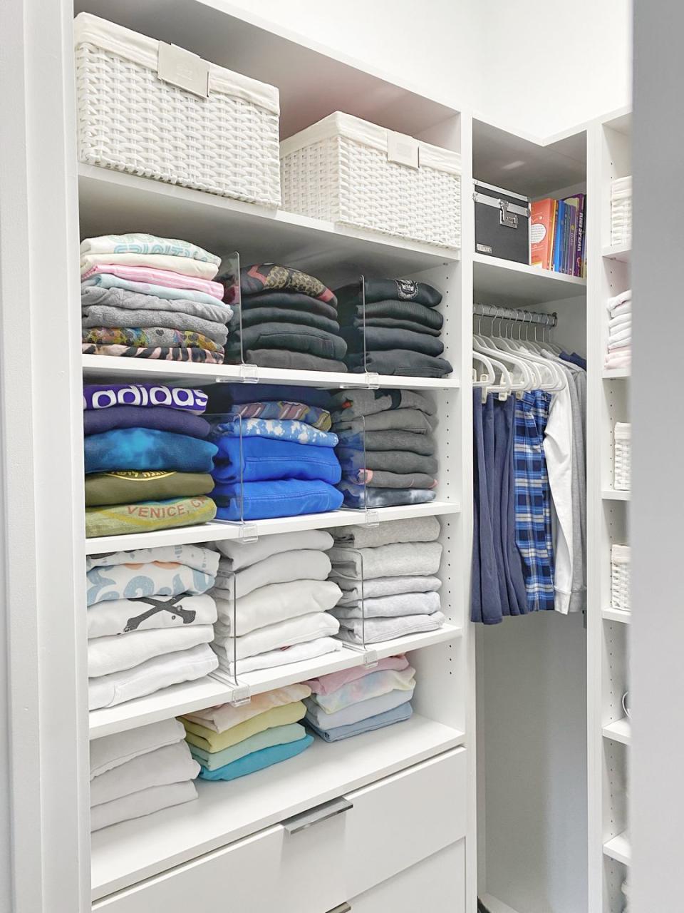 a closet full of folded clothes