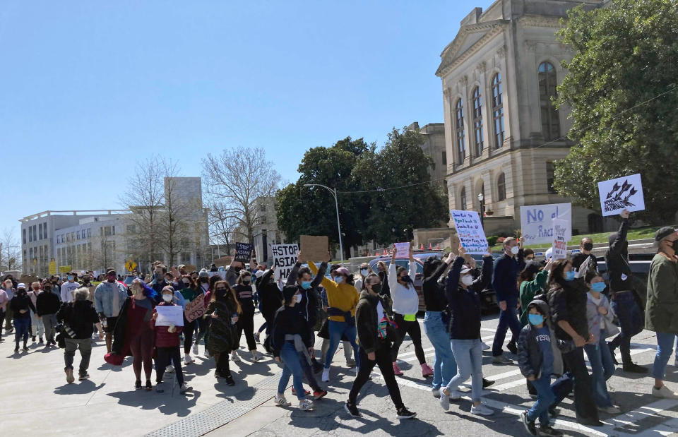 Hundreds of people gather in a park across from the Georgia state Capitol in Atlanta to demand justice for the victims of shootings at massage businesses days earlier, Saturday, March 20, 2021 in Atlanta. (AP Photo/Candice Choi)