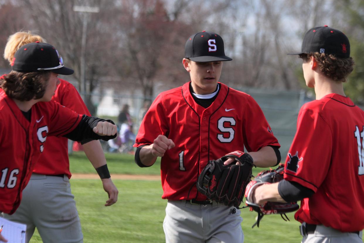 Springfield High sophomore Seth Impson is greeted by teammates during the Senators' 5-0 Central State Eight Conference victory at Chatham Glenwood on Friday, April 1.