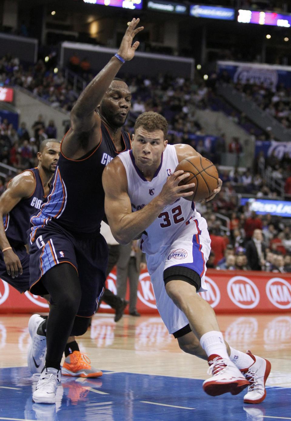 Los Angeles Clippers forward Blake Griffin (32) drives to the basket against Charlotte Bobcats center Al Jefferson during the first half of an NBA basketball game Wednesday, Jan. 1, 2014, in Los Angeles. (AP Photo/Alex Gallardo)