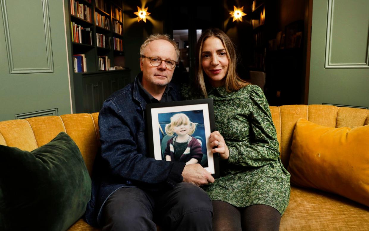 Jason Watkins and Clara Francis with a photograph of their daughter Maud, who died in 2011 - ITV