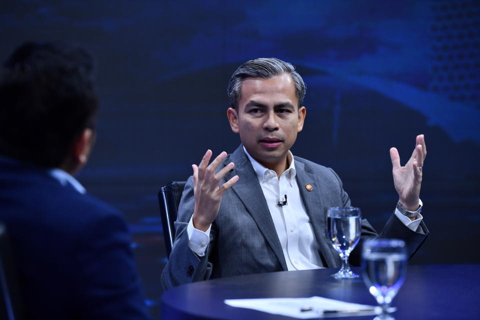 A picture of Malaysian politician, Fahmi Fadzil, talking at a summit.