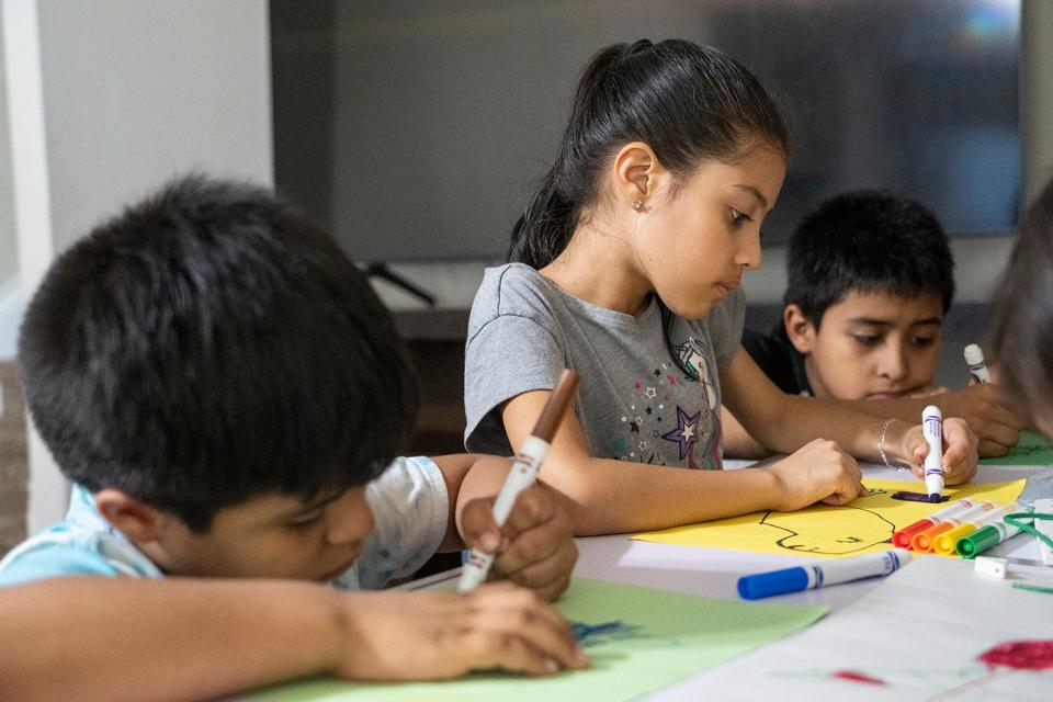 From left, Dave Mireles, 6, Casey Mireles, 7, and Dustin Mireles, 8, color together at their home last month. Their mother said she was told the state never received her documents or the documents were too old because the state waited too long to check those records, which became outdated.