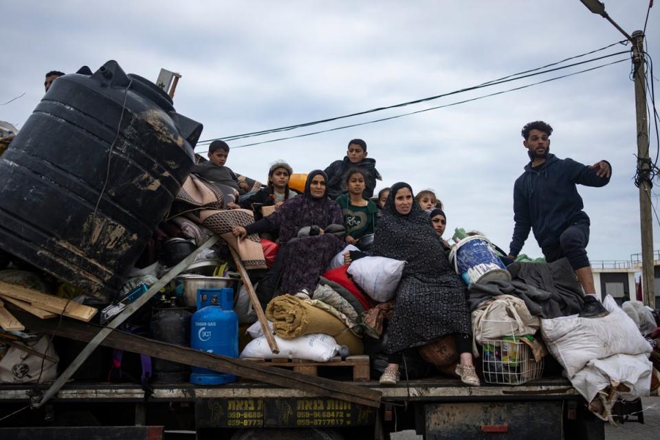 Palestinians arrive in Rafah after fleeing an Israeli ground and air offensive in the nearby city of Khan Younis on 26 January. (AP)