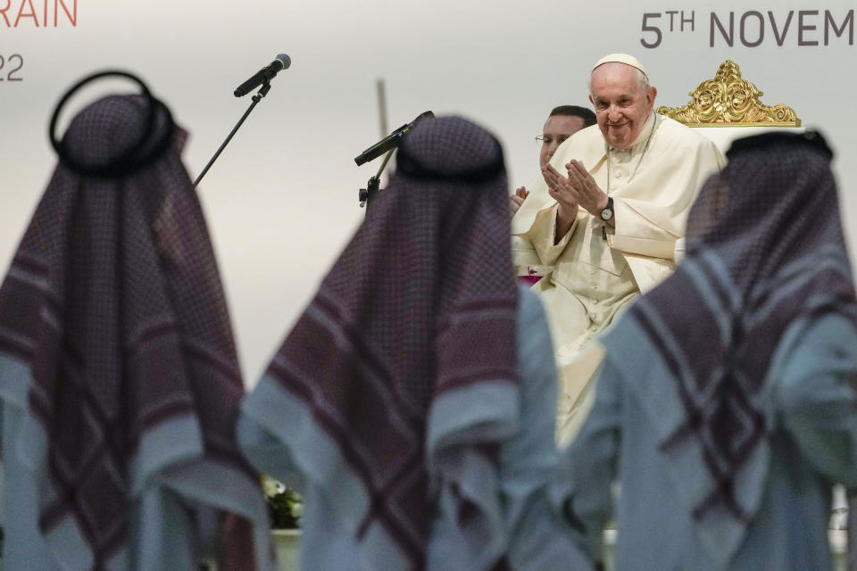 Dancers perform as Pope Francis attends a meeting with the youth at the Sacred Heart School in Manama, Bahrain, Saturday, Nov. 5, 2022. Pope Francis is making the November 3-6 visit to participate in a government-sponsored conference on East-West dialogue and to minister to Bahrain's tiny Catholic community, part of his effort to pursue dialogue with the Muslim world. (AP Photo/Alessandra Tarantino)