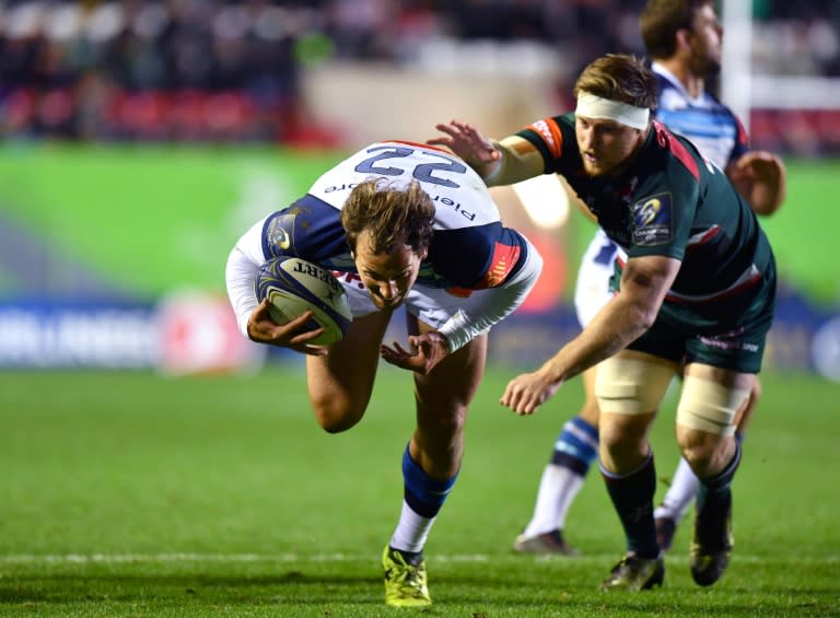 Castres' Kylian Jaminet (L) breaks through Leicester Tigers' defence during their European Champions Cup rugby union match, at Welford Road in Leicester, England, on October 21, 2017