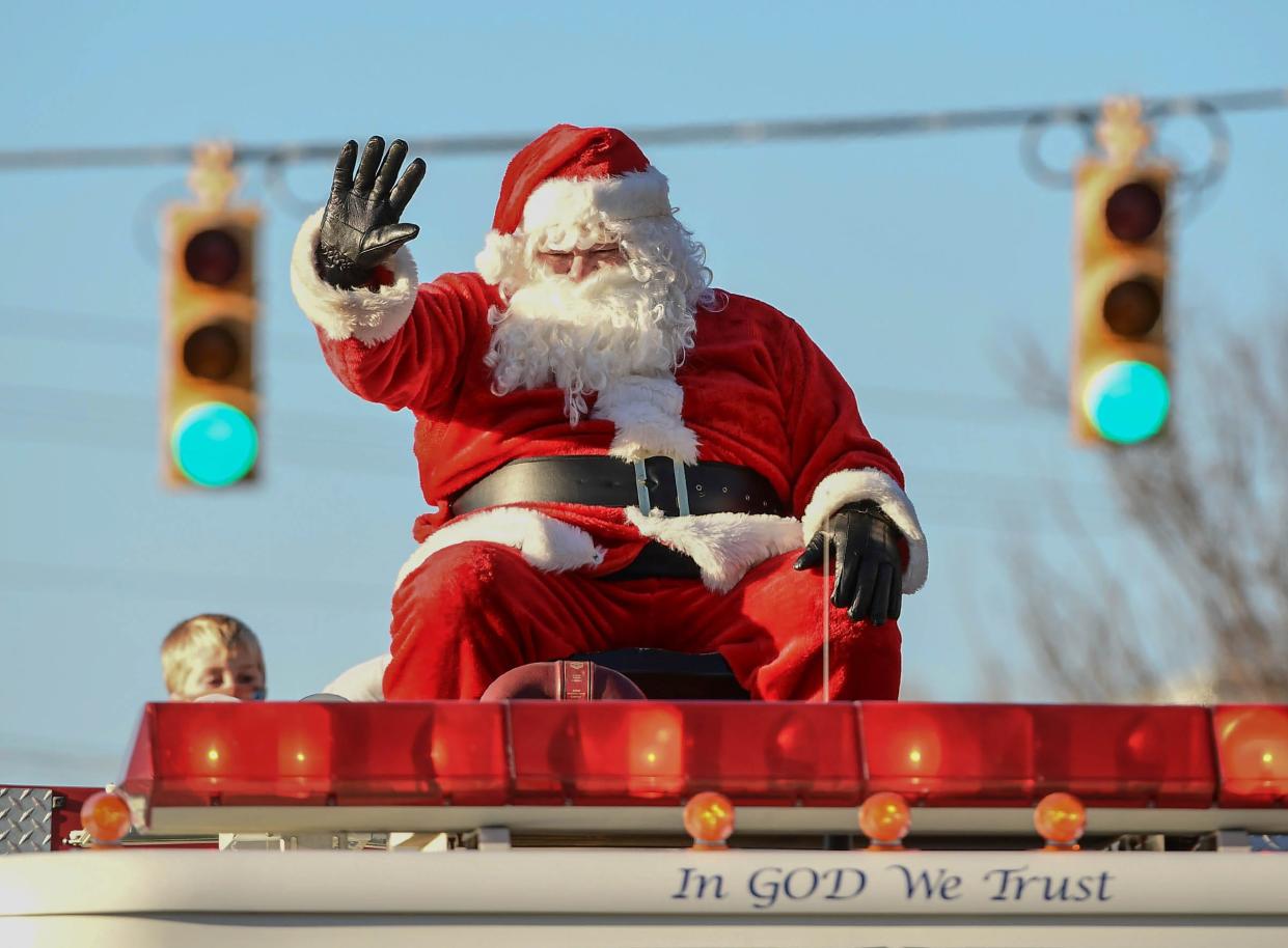 Santa Claus waves from the top of a Belton Fire truck during the Belton Christmas Parade Saturday, December 5, 2020. 