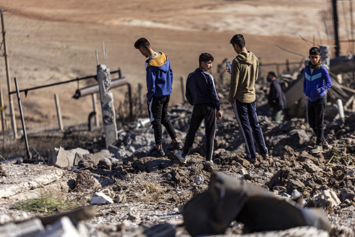 People inspect a site damaged by Turkish airstrikes that hit an electricity station in the village of Taql Baql, in Hasakeh province, Syria, November 20, 2022. / Credit: Baderkhan Ahmad/AP