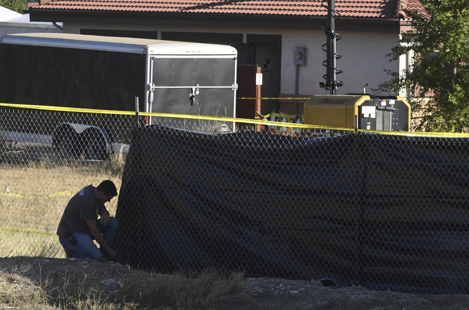 A privacy fence is set up on the perimeter of the Return to Nature Funeral Home on Monday, Oct. 9, 2023, where over 100 decomposing bodies were found last week in Penrose, Colo. (Jerilee Bennett/The Gazette via AP)
