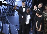 89th Academy Awards - Oscars Awards Show - Hollywood, California, U.S. - 26/02/17 - Writer and Director Barry Jenkins of "Moonlight" holds up the Best Picture Oscar in front of host Jimmy Kimmel (rear) as he stands with Producer Adele Romanski (R). REUTERS/Lucy Nicholson