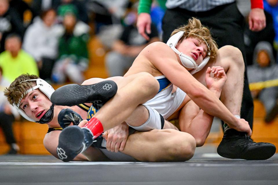 New Prairie’s Jayden Lewis and Penn’s Evan Eutsey wrestle in the 145 lb. championship Saturday, Jan. 14, 2023, at Elkhart High School. Lewis won.