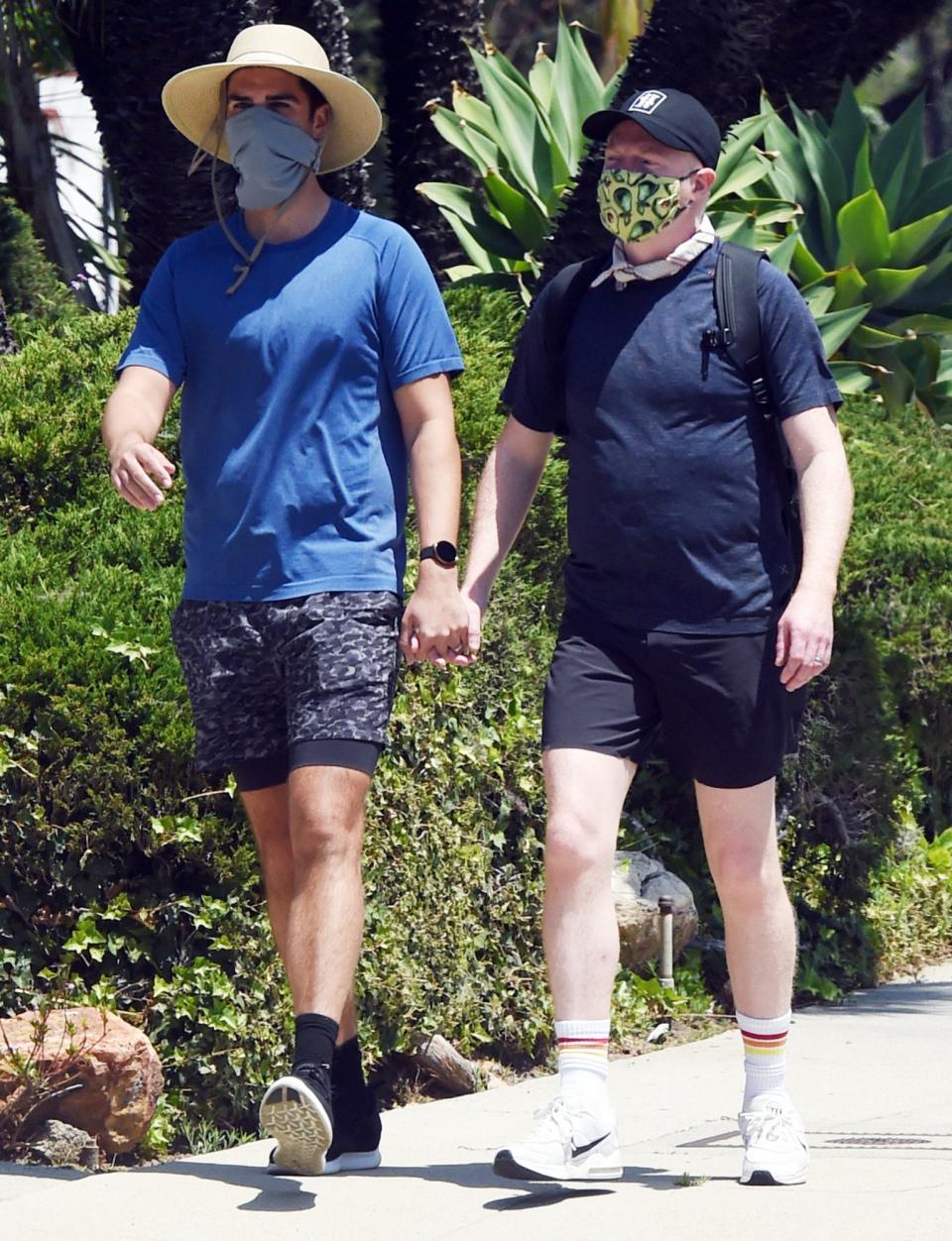 <p>New parents Jesse Tyler Ferguson and Justin Mikita hold hands on their way to run errands on Wednesday in L.A.</p>