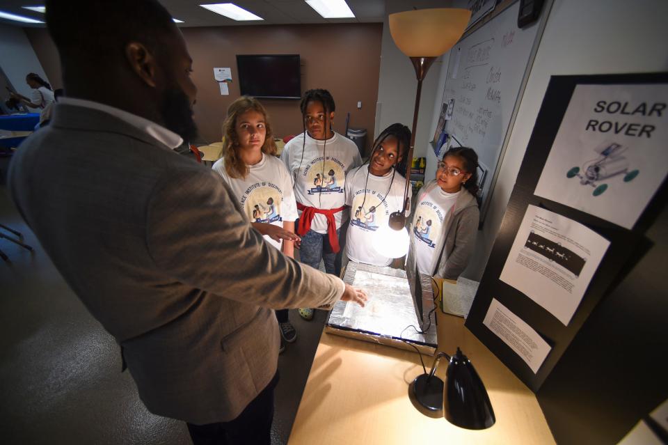 Kayden Taylor, 10, Tianna Greene, 11, Madison Ackron, 11, and Saiya Roman, 10, present their science project, Wednesday, July 6, 2022, at the Science Institute of Discovery summer camp at the Gifford Youth Achievement Center in Gifford. The science fair, "Living in Space, Preparing on Earth" prepared the students for a question-and-answer session with astronauts, Jessica Watkins and Robert Hines following the end of the fair.