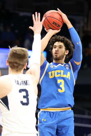UCLA's Johnny Juzang shoots over Brigham Young's Matt Haarms on March 20, 2021.