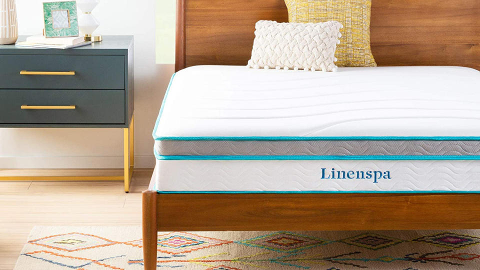 Best mattress 2022: A crop of the Linenspa mattress on a wooden frame in a bedroom scene