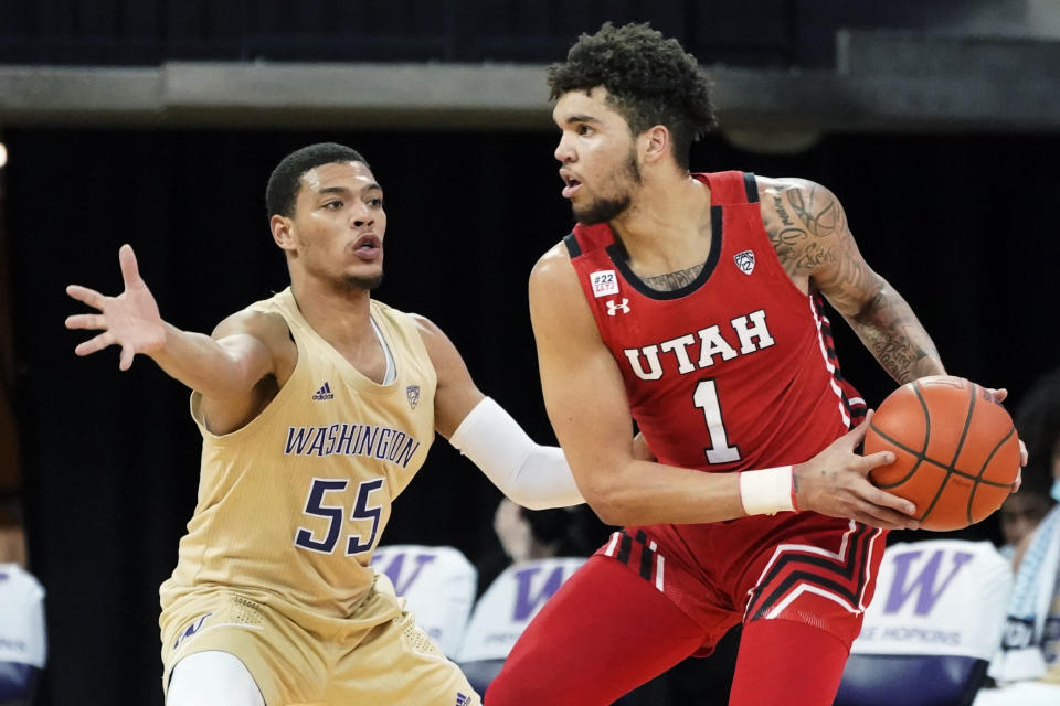 Utah forward Timmy Allen (1) tries to get around Washington guard Quade Green (55) during the first half of an NCAA college basketball game, Sunday, Jan. 24, 2021, in Seattle. (AP Photo/Ted S. Warren)