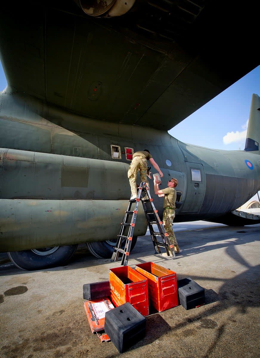 Armorers fitting flares on a C-130J at Kandahar Airfield, Afghanistan, in February 2014. <em>Crown Copyright</em><br>