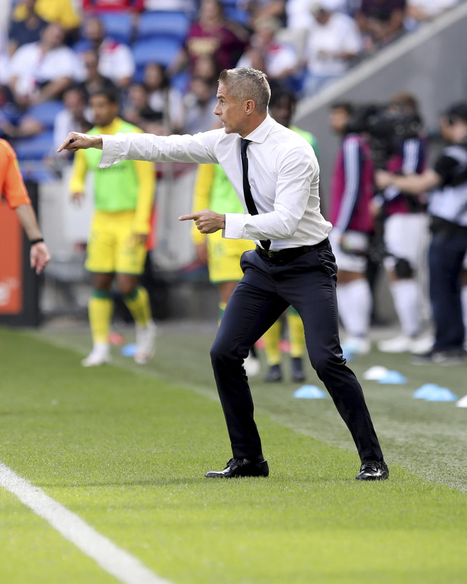 Lyon's coach Sylvinho gestures during the French League 1 soccer match between Lyon and Nantes, at the Stade de Lyon in Decines, outside Lyon, France, Saturday, Sept. 28, 2019. (AP Photo/Laurent Cipriani)