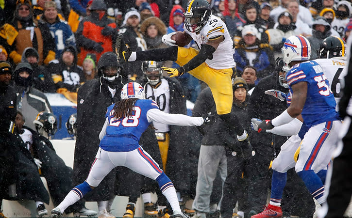 Dec 11, 2016; Orchard Park, NY, USA; Pittsburgh Steelers running back Le'Veon Bell (26) tries to jump over Buffalo Bills cornerback Ronald Darby (28) during the second half at New Era Field. Steelers beat the Bills 27-20. Mandatory Credit: Kevin Hoffman-USA TODAY Sports