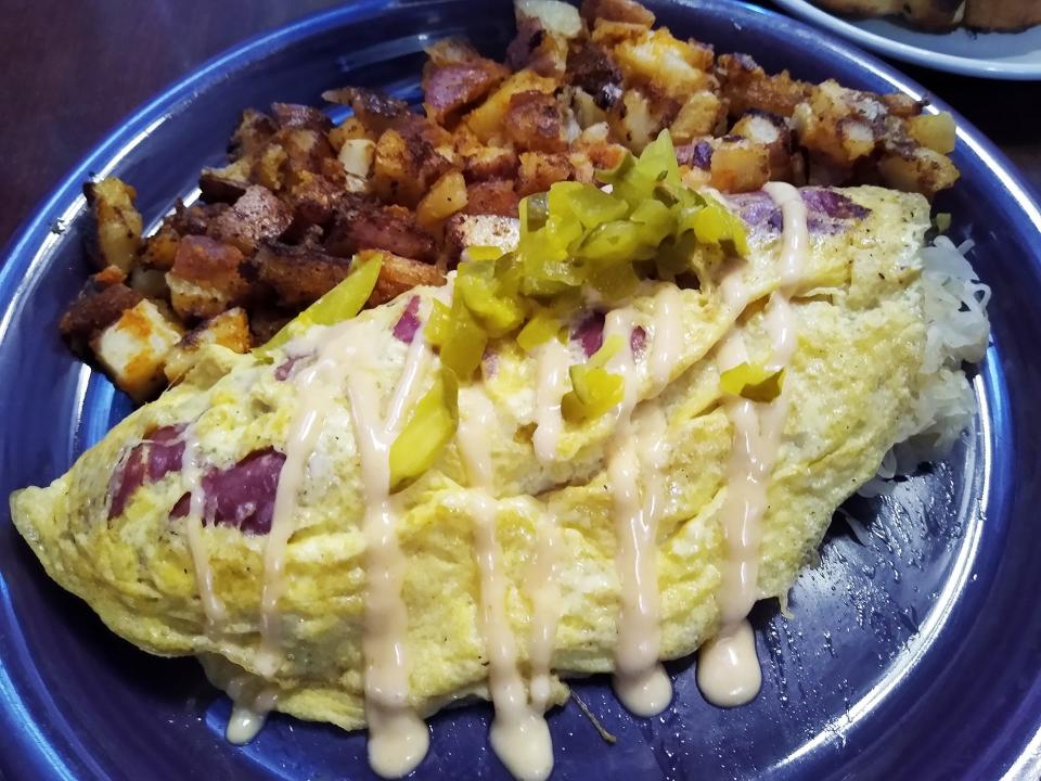 The Reuben omelet at Magic City’s Remarkable Diner is made with corned beef, sauerkraut and Swiss cheese, drizzled in Thousand Island dressing and topped with pickles. It is served with home fries.