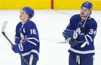 Toronto Maple Leafs forward Mitchell Marner (16) and teammate Auston Matthews (34) react after being knocked out of the Stanley Cup playoffs in Game 7 in an NHL hockey first-round playoff series against the Tampa Bay Lightning in Toronto, Saturday, May 14, 2022. (Nathan Denette/The Canadian Press via AP)