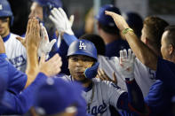 Los Angeles Dodgers' Mookie Betts is congratulated in the dugout for his three-run home run against the San Francisco Giants during the eighth inning of a baseball game Thursday, July 21, 2022, in Los Angeles. (AP Photo/Marcio Jose Sanchez)